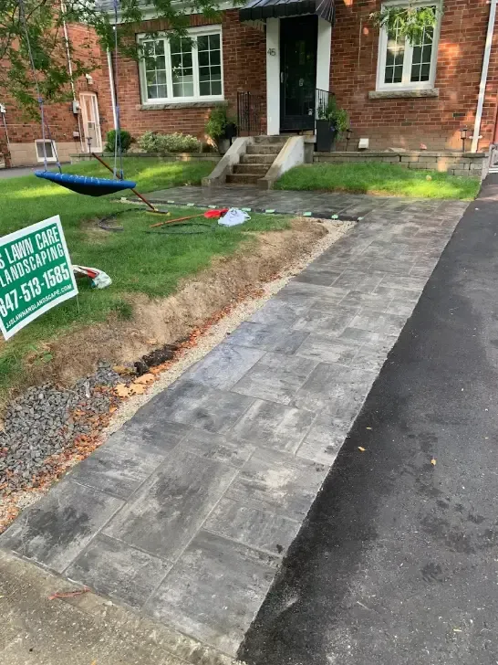 New interlock paver walkway running along the driveway of a brick Toronto home