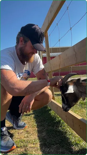 Jakub feeding a goat at a local fall fair