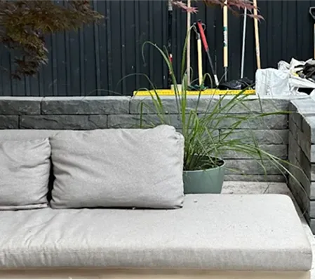 Built-in bench and block seating wall in a newly landscaped backyard